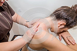 Woman masseuse doing back massage