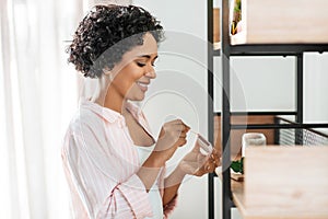 woman with matchsticks lighting candles at home