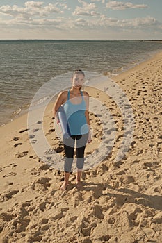 Woman with matt on beach
