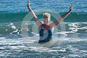 A woman of mature age in a swimsuit photo