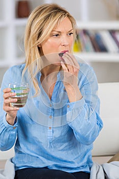 Woman mature female person taking vitamin painkiller antibiotic
