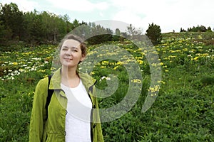 Woman in meadow with flowers at Lago-Naki Plateau