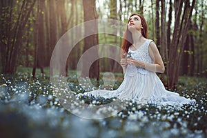 Woman in a meadow full of flowers