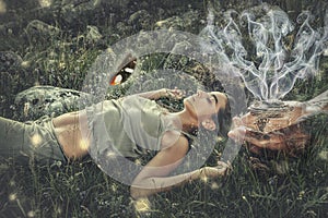 woman on meadow, incense in a woman hand.