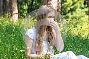 Woman in the meadow sneezes