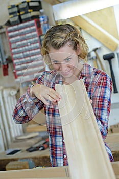 woman measure wood plank before saw