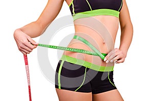 Woman measures the abdominal circumference centimeter tape photo