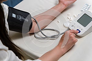 woman measures blood pressure. arterial hypotension. hand and tonometer close-up