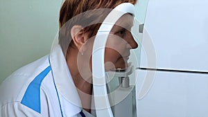 Woman measures intraocular pressure