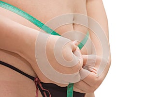 Woman measures by a tape the waist