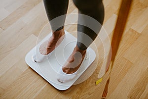Woman Measuring Body Weight At Home. weight loss control