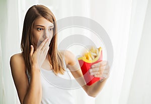 Woman Measuring Body Weight On Weighing Scale Holding Unhealthy Junk Food