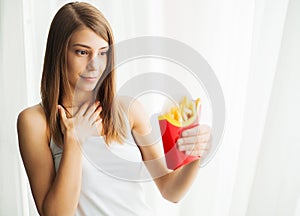 Woman Measuring Body Weight On Weighing Scale Holding Unhealthy Junk Food
