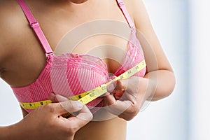 Woman measuring breast size photo