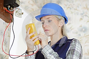 Woman measuring electrical current