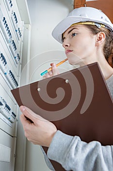 woman measuring electrical current