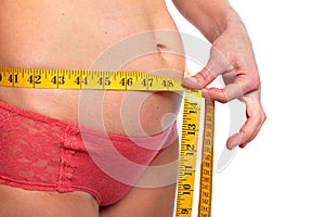 Woman measuring fat abdomen.