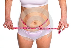 Woman measuring fat abdomen.