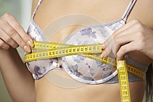 Woman Measuring Her Bra Size With Tape Measure