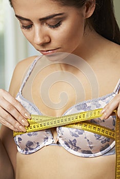 Woman Measuring Her Bra Size With Tape Measure