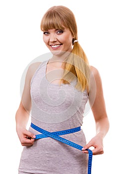 Woman measuring her waist isolated