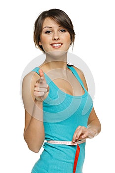 Woman measuring her waist and pointing at you