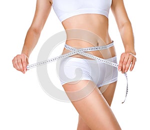 Woman measuring her waistline. Diet