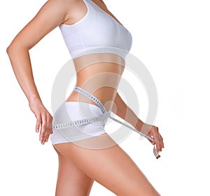 Woman measuring her waistline. Diet