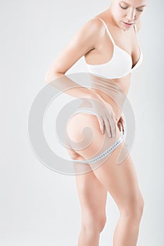 Woman measuring her waistline. Diet. Perfect Slim Body