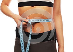 Woman measuring her waistline . Perfect Slim Body