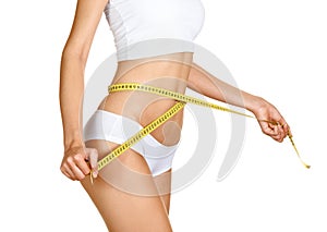 Woman measuring her waistline. Perfect Slim Body photo