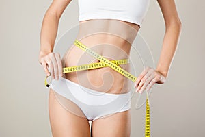 Woman measuring her waistline. Perfect Slim Body