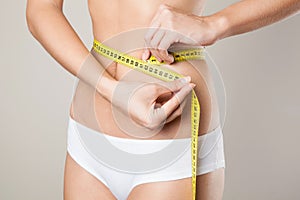 Woman measuring her waistline. Perfect Slim Body