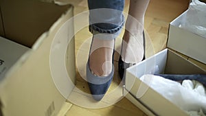 Woman measuring multiple pairs of shoes