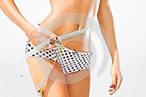 Woman measuring perfect shape of beautiful hips.
