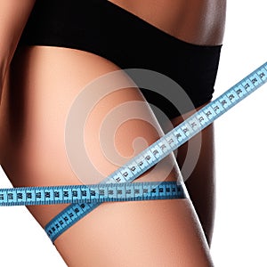 Woman measuring perfect shape of beautiful hips. Healthy lifestyles concept. Woman body part is being measured