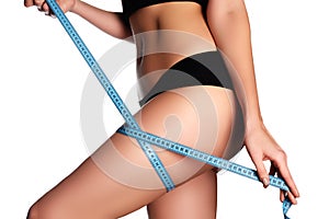 Woman measuring perfect shape of beautiful hips. Healthy lifestyles concept. Woman body part is being measured. Spa beauty part o