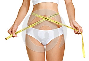 Woman measuring perfect shape of beautiful thigh