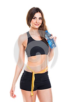 Woman measuring perfect shape of beautiful thigh with bottle of