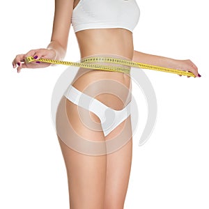 Woman measuring perfect shape of beautiful toned waist healthy