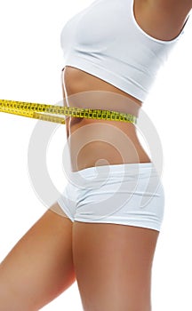 Woman measuring perfect shape of beautiful waist