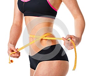 Woman measuring perfect shape of beautiful waist