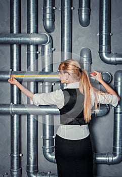 Woman measuring pipe length