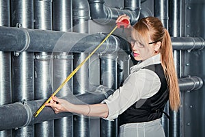 Woman measuring pipes distance