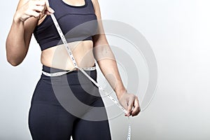 Woman measuring shape of beautiful waist