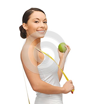Woman with measuring tape and apple