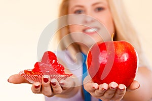 Woman with measuring tape choosing what to eat