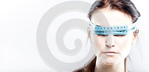 Woman with measuring tape on eyes