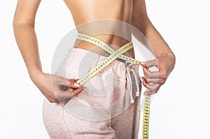 Woman with measuring tape. Weight loss concept. Woman take waist scale tape show her thin waist. Slim girl with