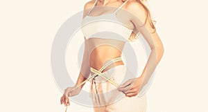 Woman with measuring tape. Weight loss concept. Woman take waist scale tape show her thin waist. Slim girl with